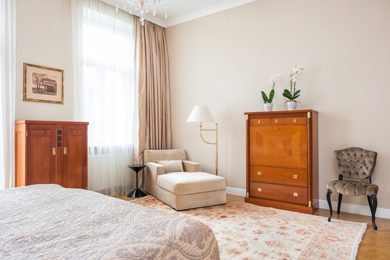 A modern bedroom with vintage mid-century furniture pieces.